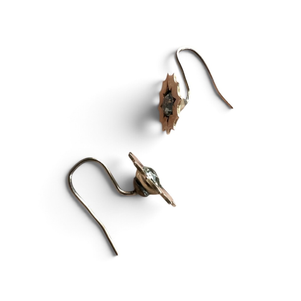 A pair of Victorian gold drop earrings featuring starburst-engraved settings with central clear round paste stones and shepherd hook fastenings. View III