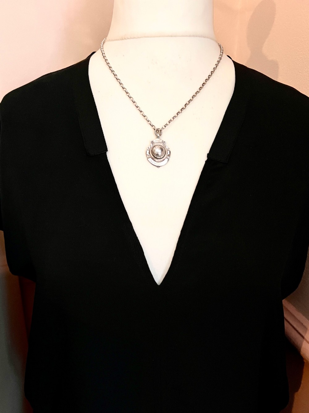 A sterling silver chain necklace featuring a shield-shaped football medal pendant engraved with 1945-6 and JR Fishley Cup. View IV