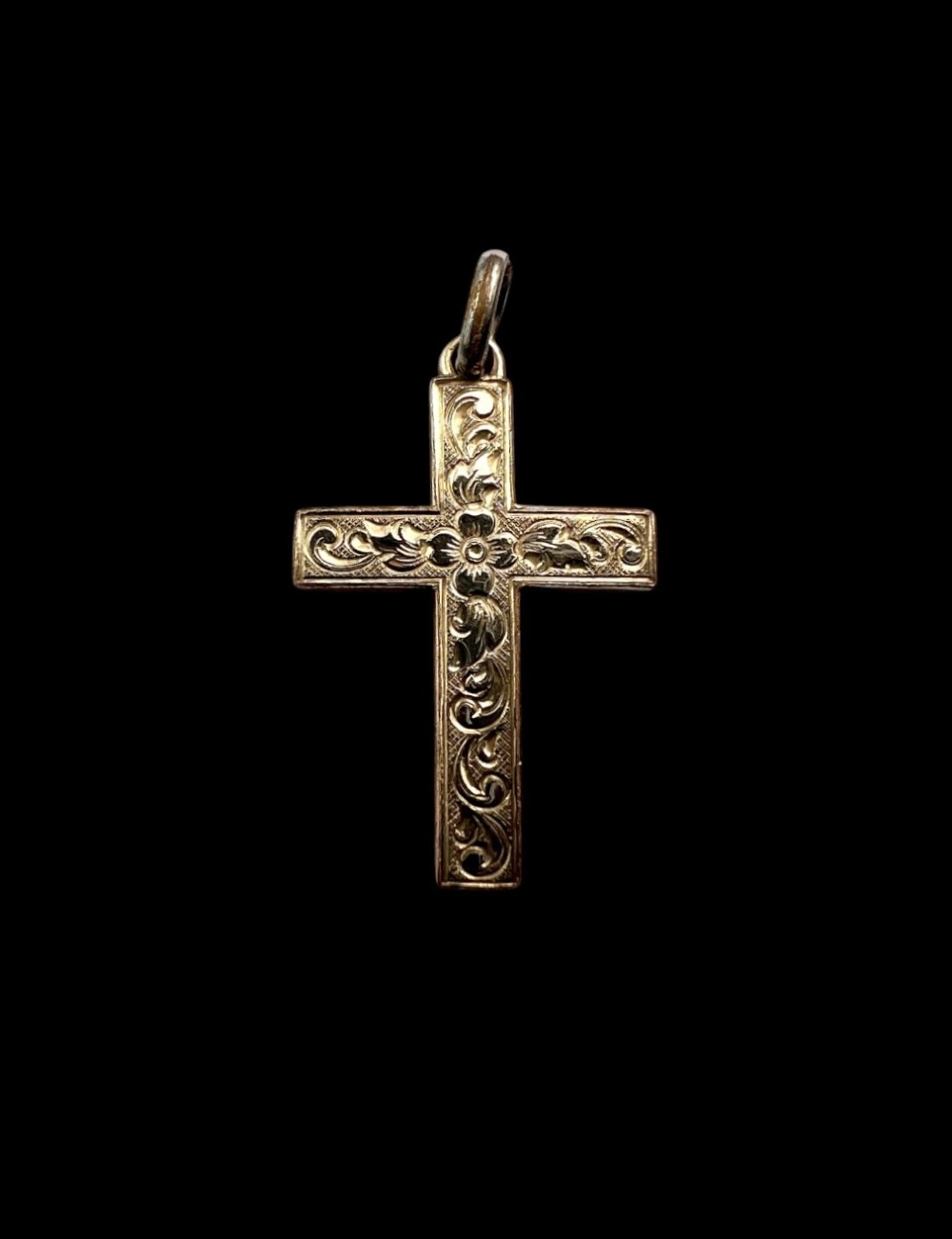 A Victorian rolled gold cross pendant featuring hand-engraved floral and scrollwork motifs with a suspension loop at the top. View IV