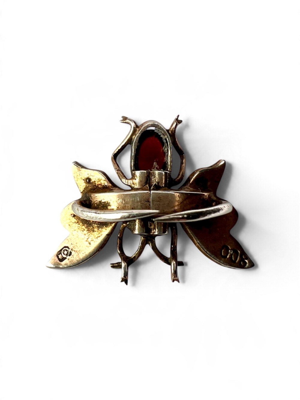 A Victorian silver gilt brooch shaped like an insect, featuring a cabochon red garnet body and wings accented with small seed pearls. View IV