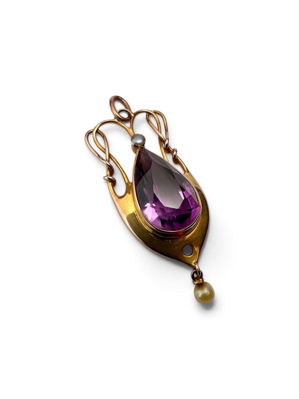 An Art Nouveau gold pendant features an openwork whiplash frame surrounding a central pear-cut purple amethyst gemstone, anchored by a small pearl above and a dangling seed pearl below. View III