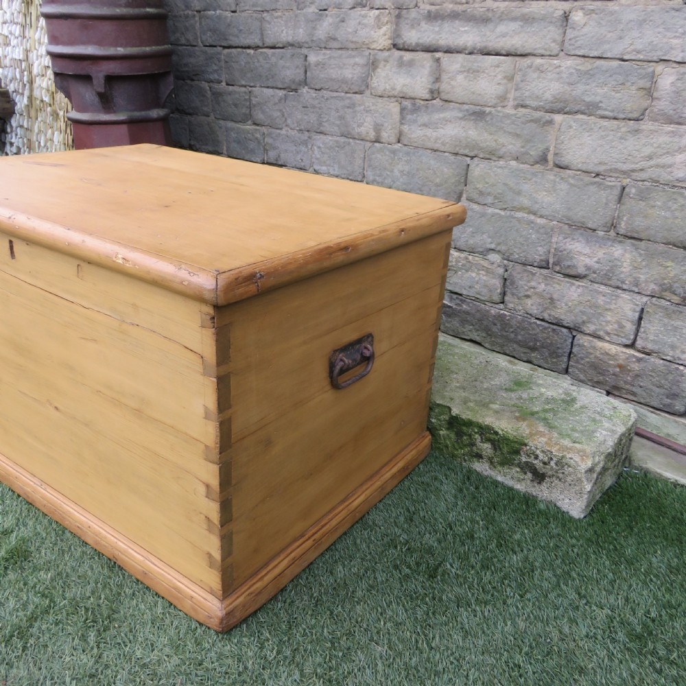 A rectangular Victorian pine blanket chest featuring visible dovetail joint corner construction, a hinged top lid, and a moulded base. View II