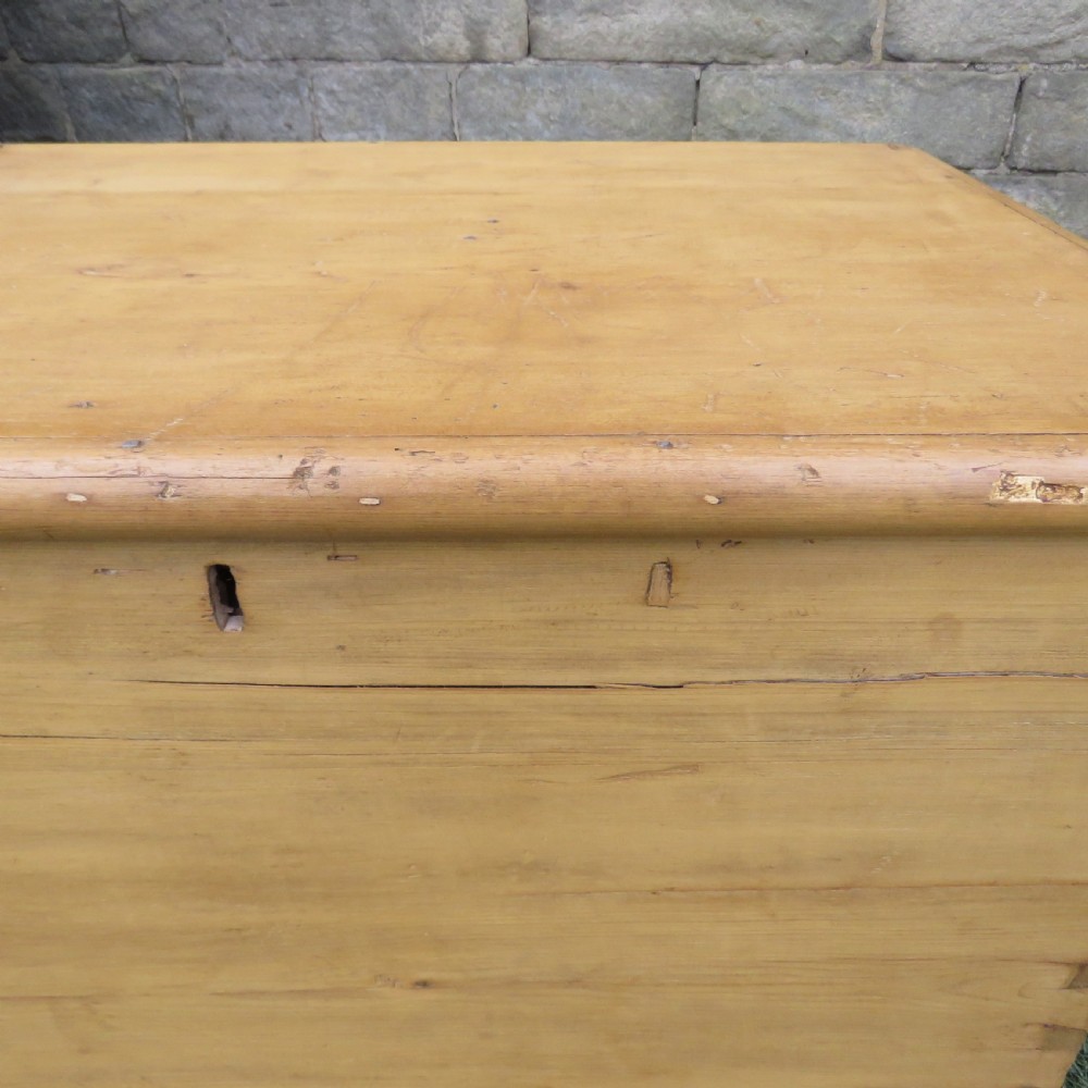 A rectangular Victorian pine blanket chest featuring visible dovetail joint corner construction, a hinged top lid, and a moulded base. View V