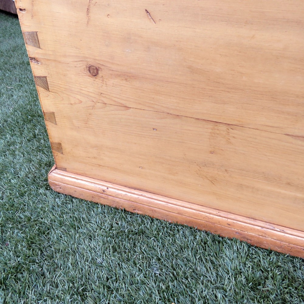 A rectangular Victorian pine blanket chest featuring visible dovetail joint corner construction, a hinged top lid, and a moulded base. View VII