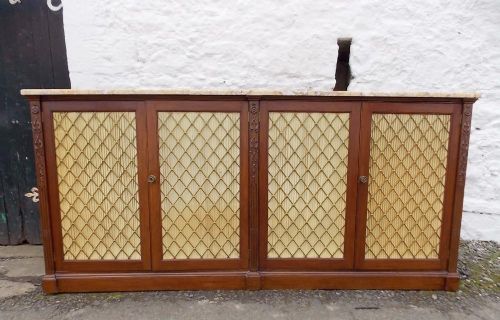 A Regency Mahogany Stained Bookcase with Marble Top,