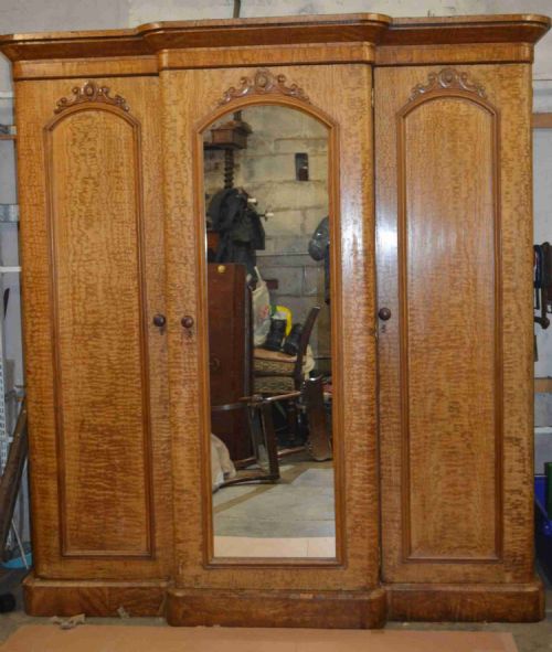 A Victorian Breakfront Fiddleback Ash Three Door Mirror Wardrobe