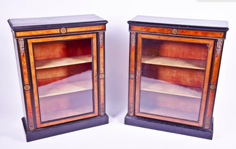 A pair of Victorian ebonised, ormolu burr walnut pier cabinets 