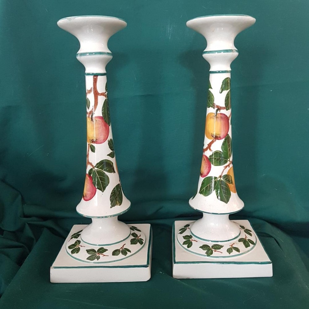 A large pair of Wemyss ware candlesticks decorated with apples