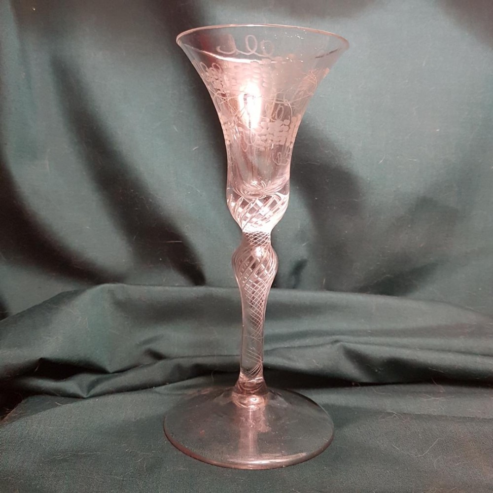 An engraved airtwist stem wine glass mid 18th century the bell bowl