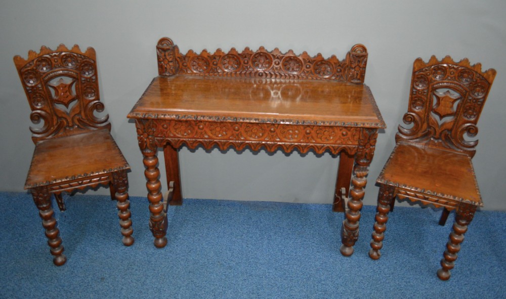 Victorian carved oak hall table and matching side chairs