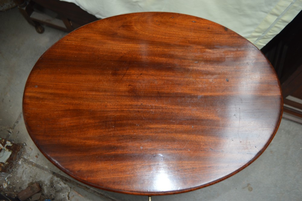 An 18th-century George III oval mahogany wine cooler with polished brass bindings and tapered legs on castors. View V