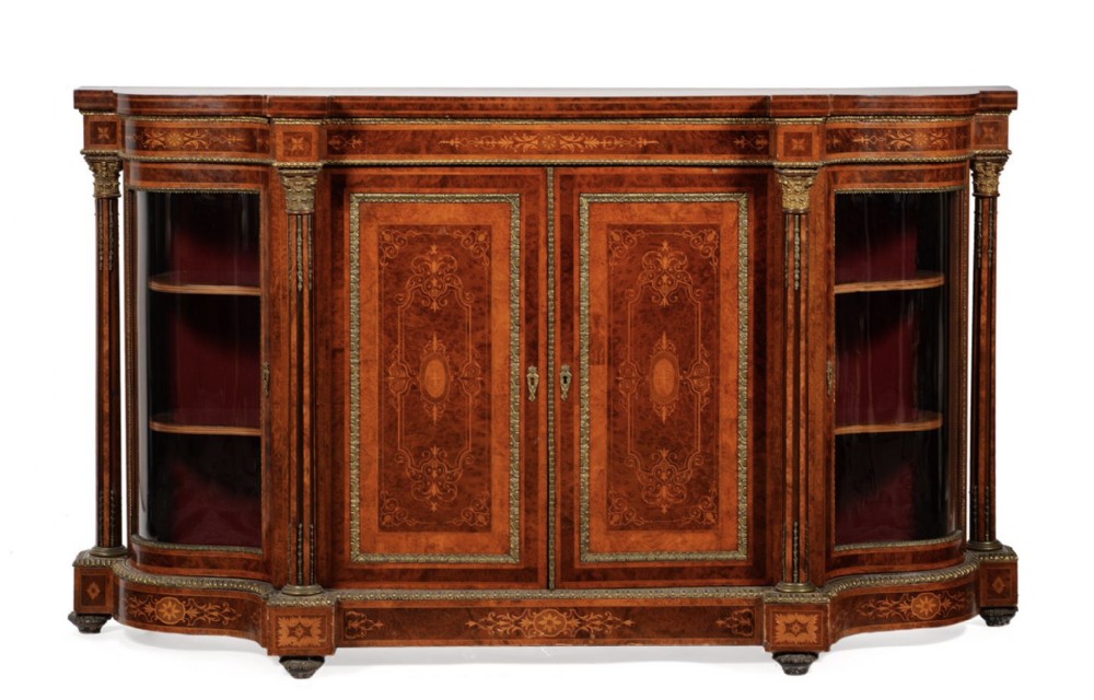 A nineteenth-century Victorian side cabinet crafted from burr yew and walnut, featuring detailed marquetry inlay, gilt-brass mounts, central cupboard doors, and curved glass end display doors.