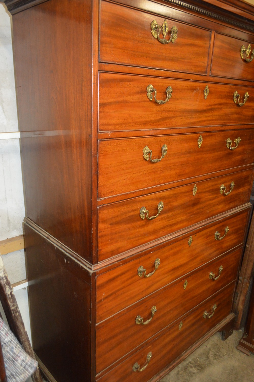 An antique Georgian mahogany chest-on-chest featuring two short drawers over six long graduated drawers with brass swan-neck handles and bracket feet. View II
