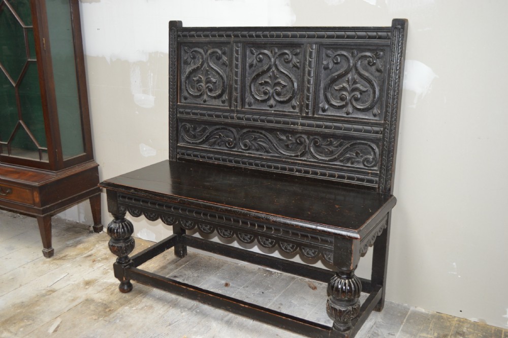 A 19th century carved oak hall bench