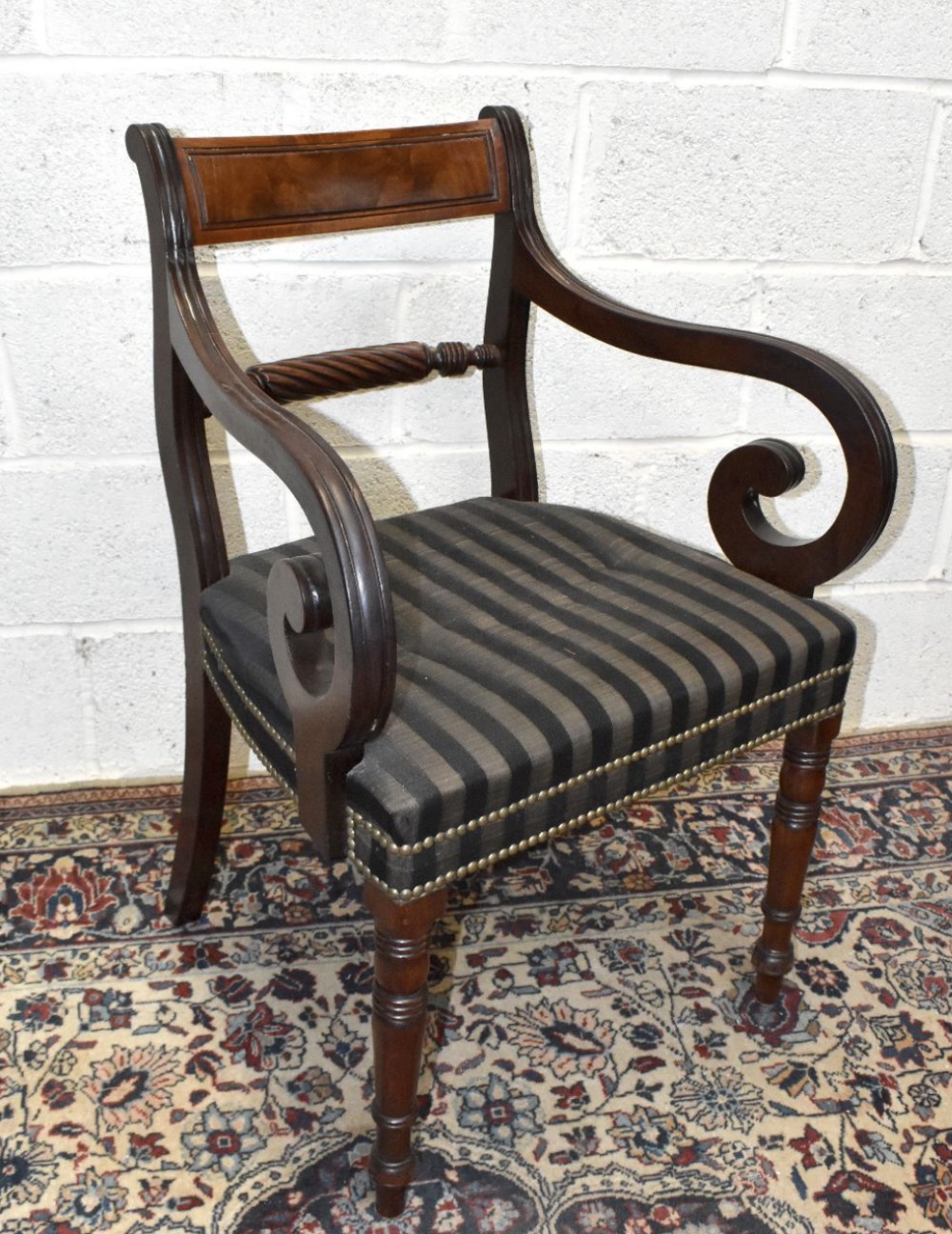 A quality Regency mahogany open sided elbow chair
