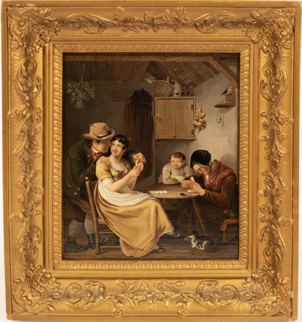 A 19th-century oil painting depicting a rustic interior scene with four figures around a wooden table, set inside an ornate giltwood frame.