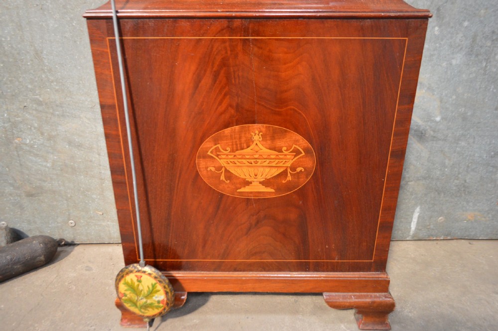A tall Georgian mahogany longcase clock featuring an arched hood, a brass and spandrel dial with a moon phase disk, and an inlaid central door. View IV