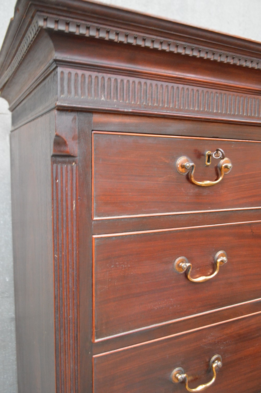 A tall Georgian mahogany chest on chest featuring two short over six long drawers with brass swan-neck handles and a dentil corniced top. View III