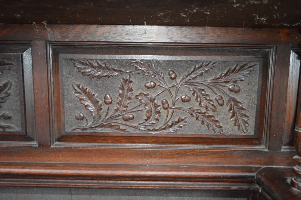 A Victorian carved oak fire surround. View II