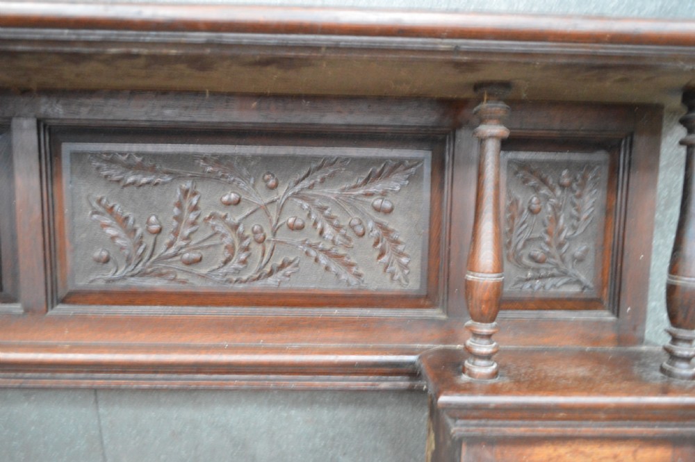 A Victorian carved oak fire surround. View III