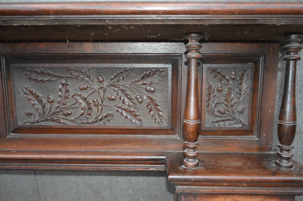 A Victorian carved oak fire surround. View IV