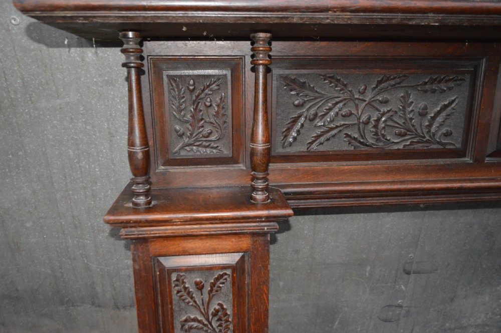 A Victorian carved oak fire surround. View VII