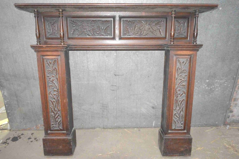 A Victorian carved oak fire surround.