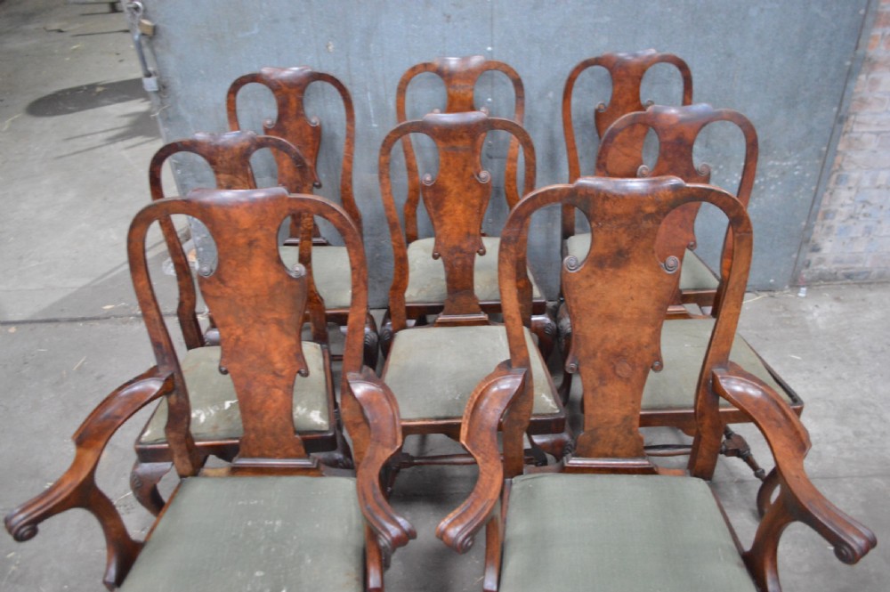 A set of George II burr walnut dining chairs featuring shaped vasiform back splats, upholstered drop-in seats, and cabriole legs. View VI