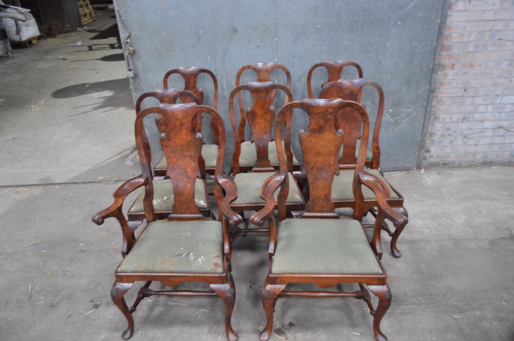 A set of George II burr walnut dining chairs featuring shaped vasiform back splats, upholstered drop-in seats, and cabriole legs. View VII
