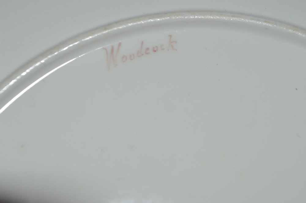 A circular Royal Worcester porcelain cabinet plate featuring a central hand-painted scene of game birds in flight surrounded by a dark cobalt blue rim with gold scrollwork gilding. View XVIII