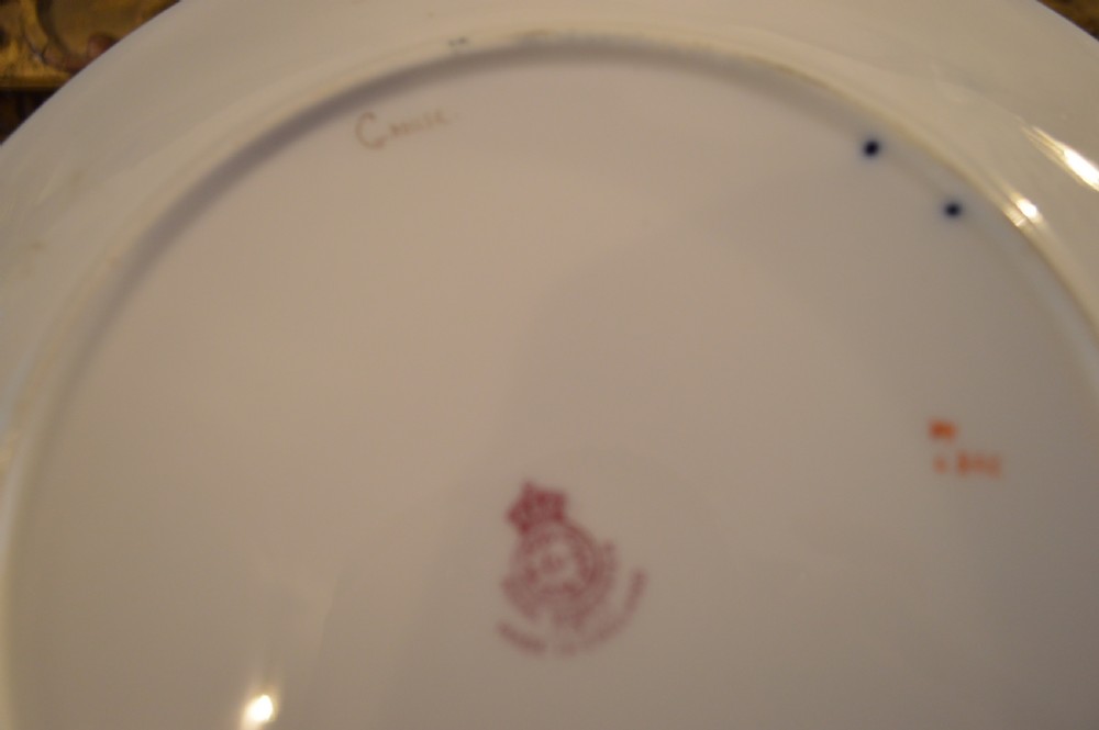 A circular Royal Worcester porcelain cabinet plate featuring a central hand-painted scene of game birds in flight surrounded by a dark cobalt blue rim with gold scrollwork gilding. View XXIV