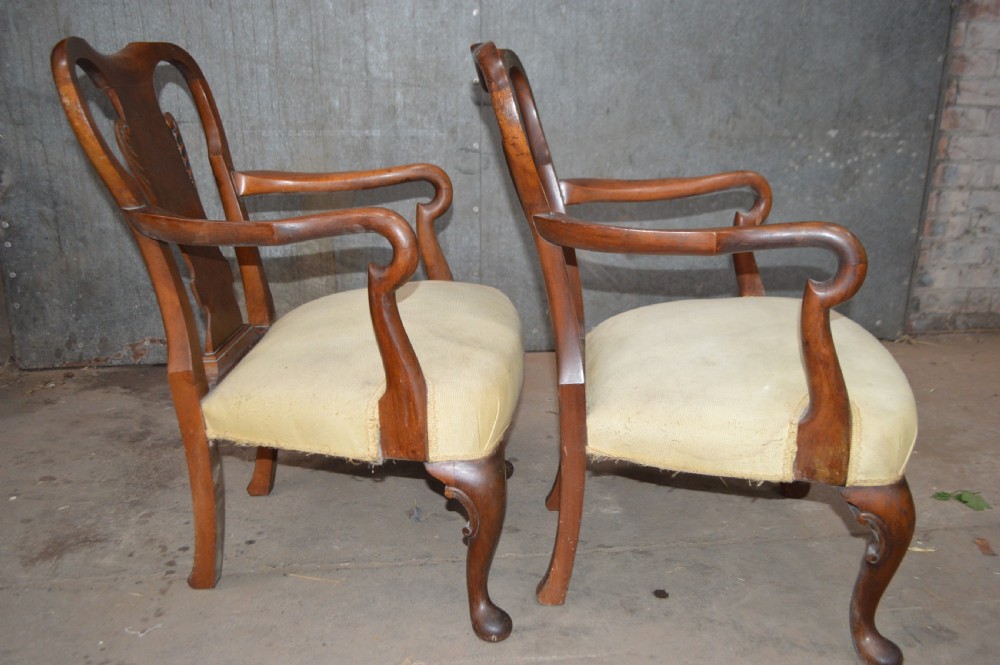 A pair of antique burr walnut low-seated armchairs with vasiform splats, carved cabriole legs, and yellow upholstered seats. View V