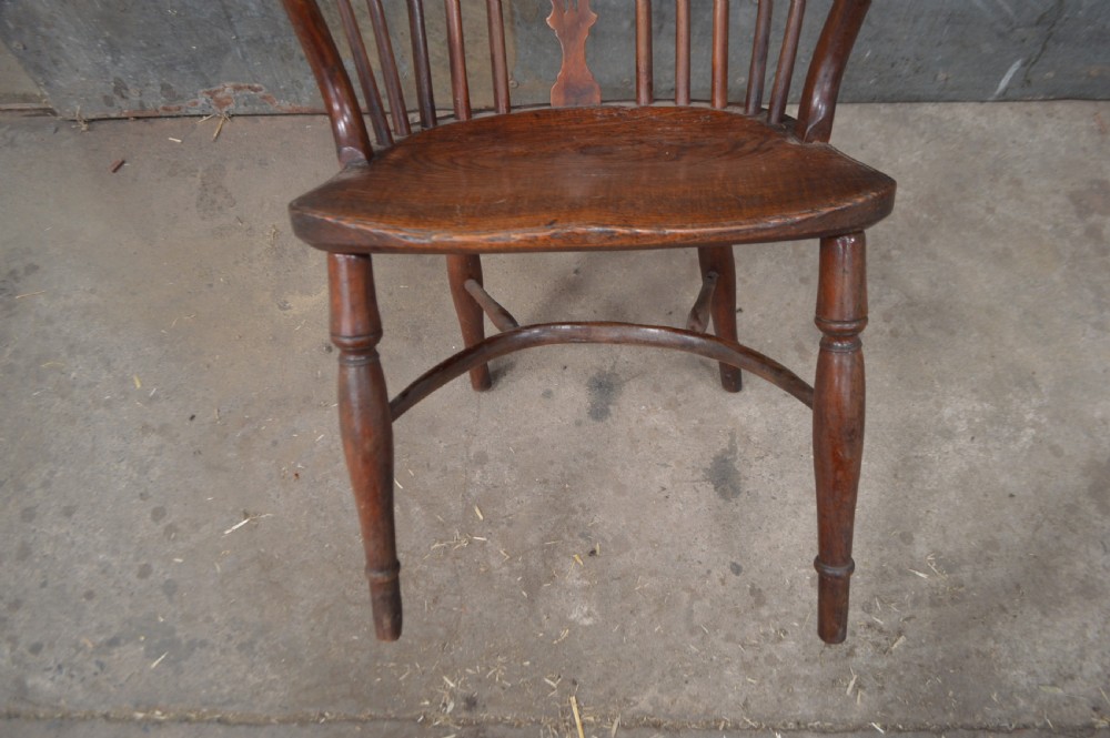 A Victorian low back Windsor armchair crafted from warm brown wood, featuring a bentwood arm bow, turned legs, and a decorative central pierced splat. View II