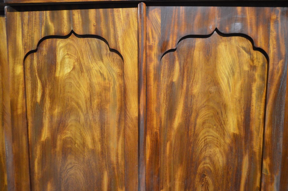 A nineteenth-century Victorian four-door breakfront wardrobe featuring flame mahogany panelled doors and a moulded top cornice. View III