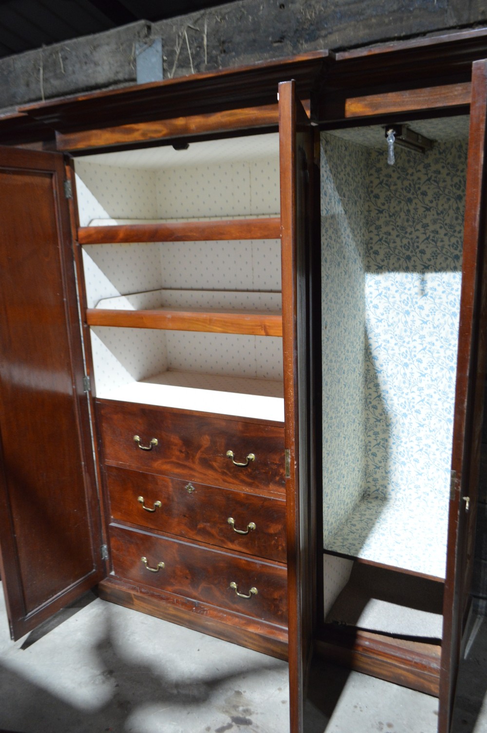 A nineteenth-century Victorian four-door breakfront wardrobe featuring flame mahogany panelled doors and a moulded top cornice. View VI