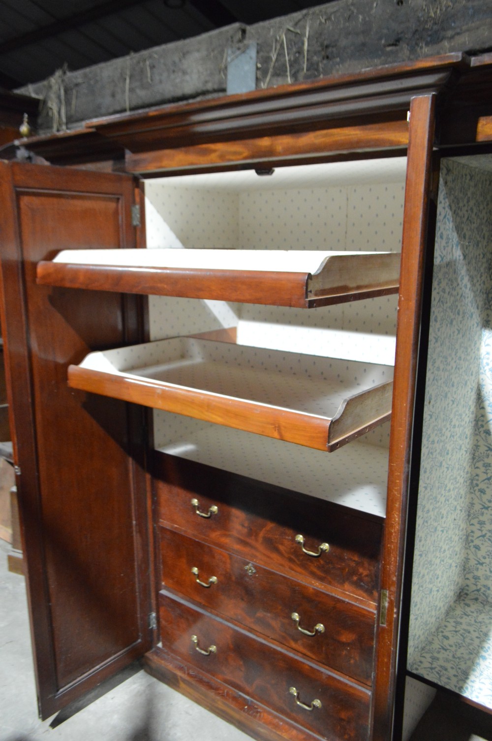 A nineteenth-century Victorian four-door breakfront wardrobe featuring flame mahogany panelled doors and a moulded top cornice. View IX