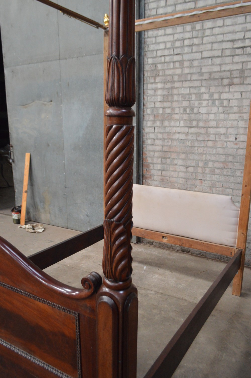 Victorian mahogany four poster bed featuring carved spiral posts, gilt finials, and an arched panelled footboard. View II