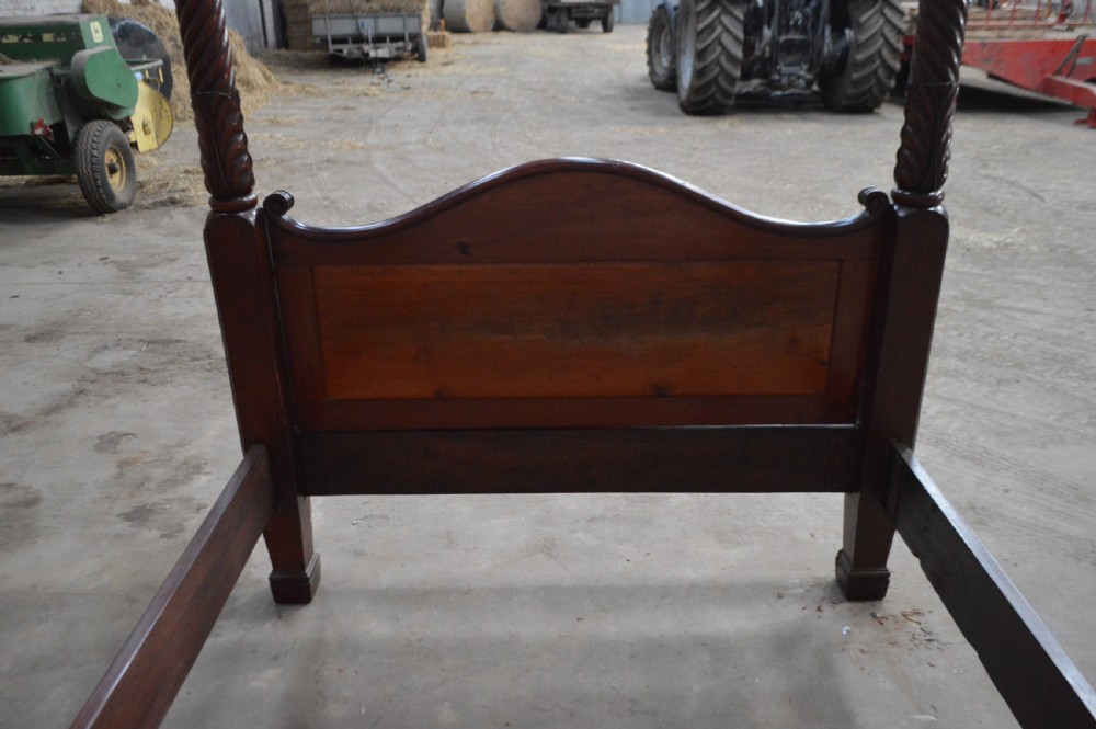 Victorian mahogany four poster bed featuring carved spiral posts, gilt finials, and an arched panelled footboard. View IV