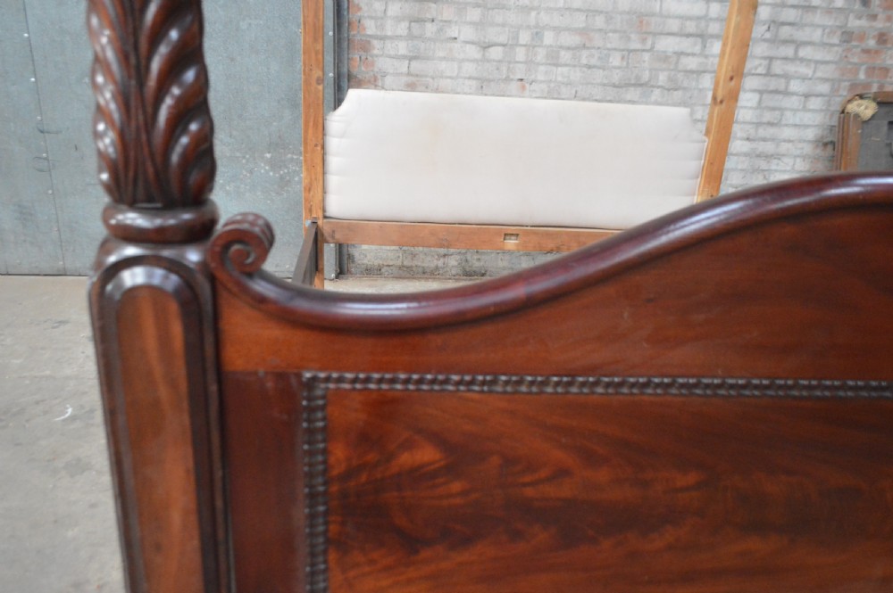 Victorian mahogany four poster bed featuring carved spiral posts, gilt finials, and an arched panelled footboard. View VII