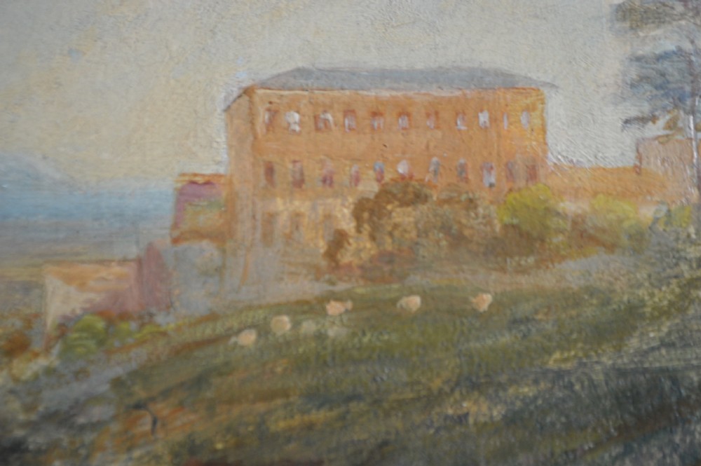 A 19th-century oil painting depicting a countryside river landscape with two seated figures in the foreground and a large building on a hill in the distance under a cloudy sky. View V