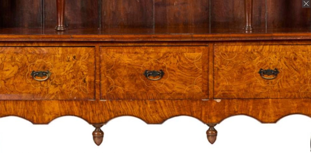 An antique burr walnut and elm dresser featuring an upper open rack with arched side cupboards, three drawers, turned supports, and a lower potboard base. View II