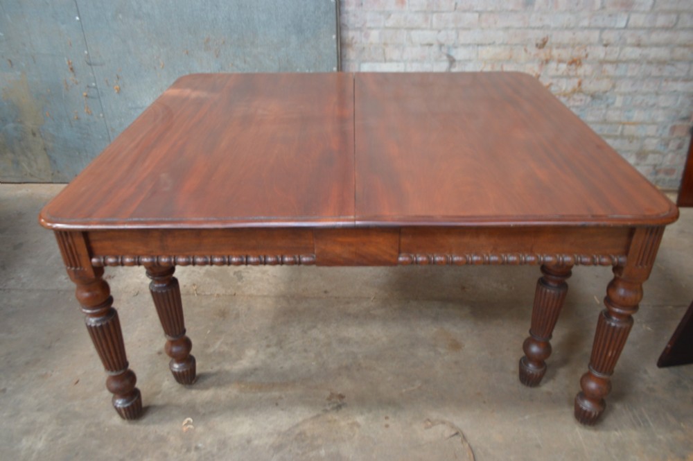 A long late Regency mahogany extending dining table featuring reeded turned legs on brass castors. View VII