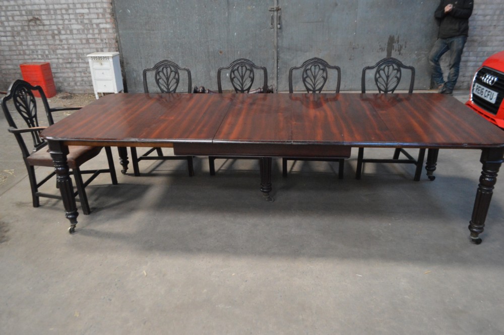 A long late Regency mahogany extending dining table featuring reeded turned legs on brass castors. View VIII