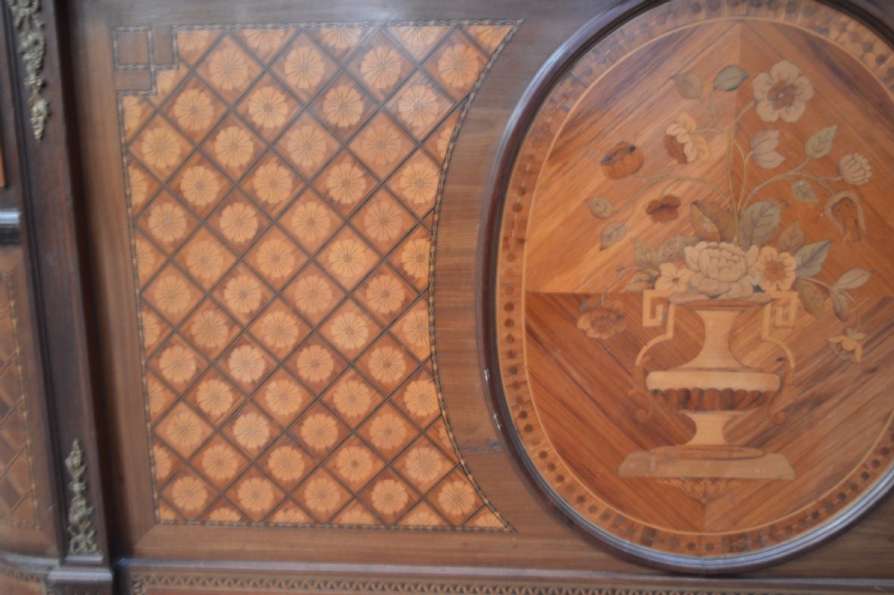 A French Louis XVI Revival wooden double bed featuring intricate floral marquetry paneling, trellis parquetry, curved footboard ends, and gilded metal mounts. View III