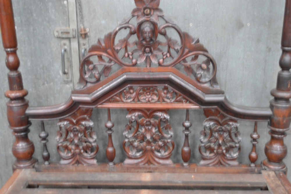 A nineteenth-century mahogany four-poster bed featuring hand-carved floral cresting, turned posts, and a decorative spindle headboard. View XIV
