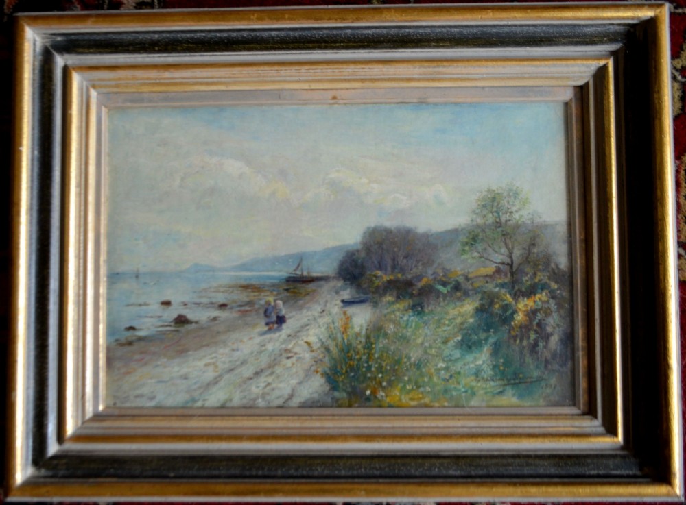 An antique oil painting depicting two figures walking along a sandy shore with a sailboat in the background, set within a black and gilt wooden frame. View VI