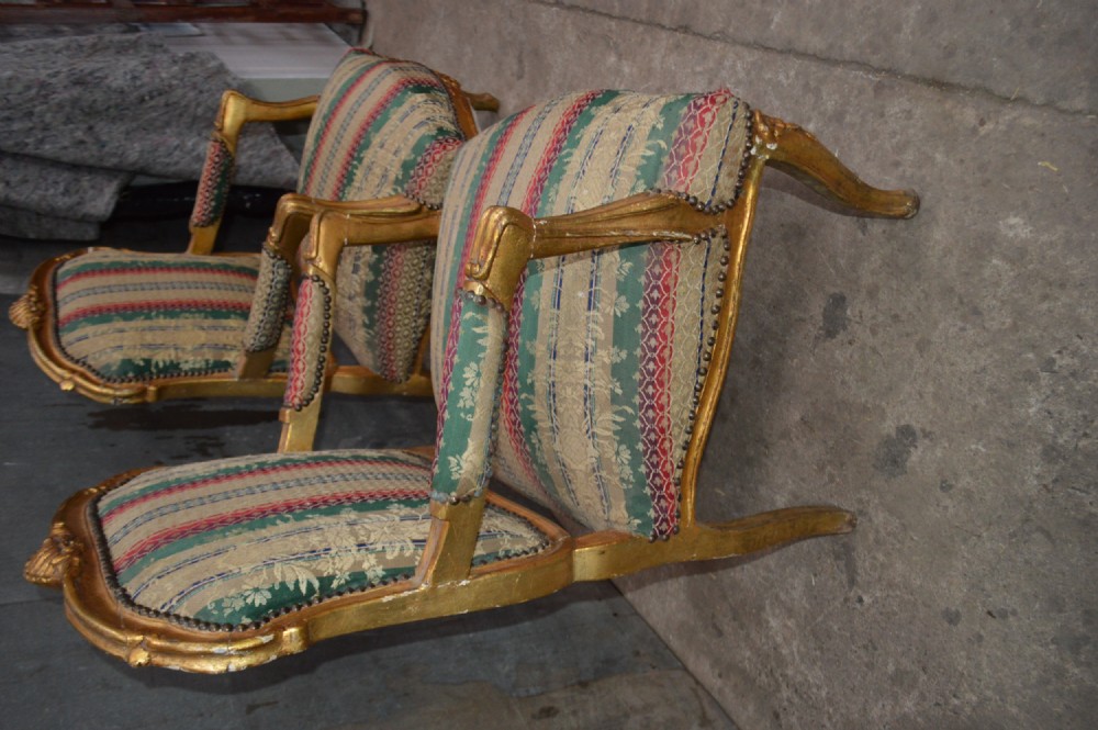 A pair of 19th-century French giltwood salon armchairs featuring carved crests, cabriole legs, and striped botanical woven fabric. View III