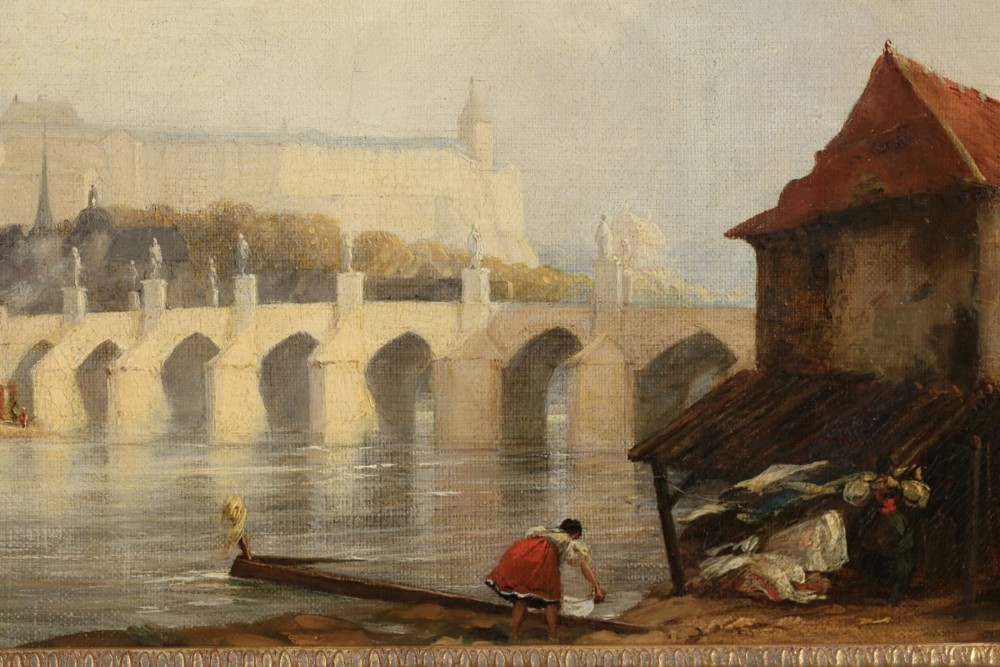 An 1830s English oil painting depicting the Charles Bridge and Prague Castle across a river, set within a gilded fluted frame. View VI