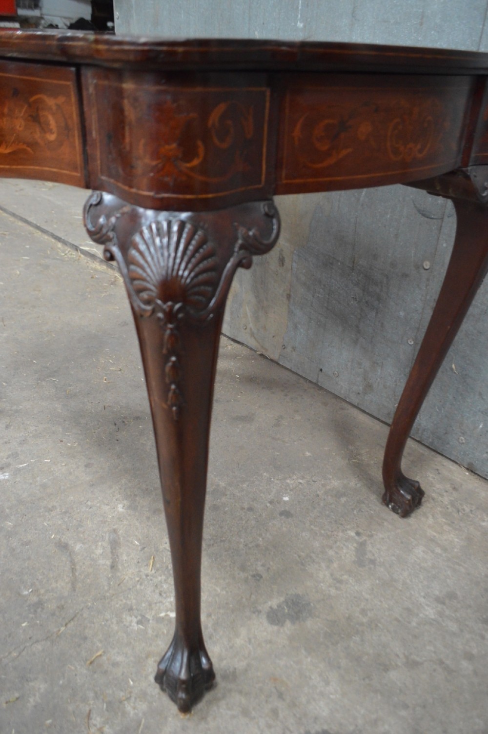 An 18th-century Dutch side table featuring floral marquetry inlay across a serpentine top, supported by cabriole legs with shell-carved knees and claw-and-ball feet. View II