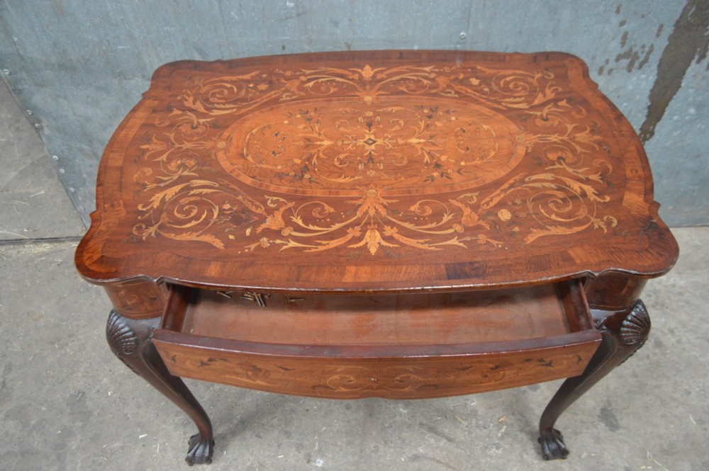 An 18th-century Dutch side table featuring floral marquetry inlay across a serpentine top, supported by cabriole legs with shell-carved knees and claw-and-ball feet. View III